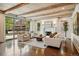 Open-concept living room with fireplace, wood beams, and neutral decor at 1050 S Gilpin St, Denver, CO 80209
