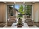 Bright living room featuring neutral armchairs and sliding glass doors to an outdoor patio at 1050 S Gilpin St, Denver, CO 80209
