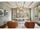 Home office with fireplace, wood beams, and ample light at 1050 S Gilpin St, Denver, CO 80209