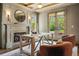 Home office with fireplace, wood beams, french doors and cozy chairs at 1050 S Gilpin St, Denver, CO 80209