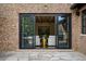 Expansive glass doors open from the brick patio to the home's interior at 1050 S Gilpin St, Denver, CO 80209