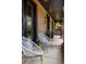 Covered porch with seating and black trim at 1050 S Gilpin St, Denver, CO 80209