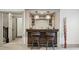 Basement wet bar with counter seating, custom lighting, and an adjacent hallway at 1050 S Gilpin St, Denver, CO 80209