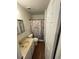 Bathroom with vanity sink, toilet, and walk-in shower with curtain at 2241 Dexter Dr # 2, Longmont, CO 80501