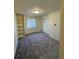 Bright bedroom features plush carpeting, built-in shelving, and a window for natural light at 2241 Dexter Dr # 2, Longmont, CO 80501