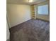 Bright bedroom features plush carpeting, built-in shelving, and a window for natural light at 2241 Dexter Dr # 2, Longmont, CO 80501