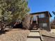Two story brick building showing front stairway and small balcony with concrete walkway at 2241 Dexter Dr # 2, Longmont, CO 80501