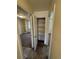 Hallway view showing access to other rooms and a storage closet with shelving at 2241 Dexter Dr # 2, Longmont, CO 80501
