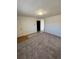 The living room is well-lit and carpeted at 2241 Dexter Dr # 2, Longmont, CO 80501