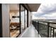 Balcony with city views, accessible from a living room with hardwood floors and neutral paint at 1643 Boulder St # 211, Denver, CO 80211