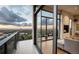 Balcony with seating offering city views, accessible from a living room with a fireplace at 1643 Boulder St # 211, Denver, CO 80211