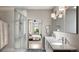 Contemporary bathroom with a double sink vanity, modern lighting fixtures, and a glass-enclosed shower at 1643 Boulder St # 211, Denver, CO 80211