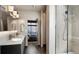 Modern bathroom featuring double sinks, contemporary lighting, and a glass-enclosed shower at 1643 Boulder St # 211, Denver, CO 80211