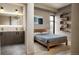 Bedroom with a contemporary design, wooden bedframe, and an ensuite bathroom with a double vanity at 1643 Boulder St # 211, Denver, CO 80211