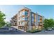 Modern three-story building with balconies, storefront windows, lush landscaping and street access at 1643 Boulder St # 211, Denver, CO 80211