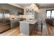 Modern kitchen with stainless steel appliances, a large island, and pendant lighting at 1643 Boulder St # 211, Denver, CO 80211