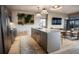 Open kitchen with stainless steel appliances, a large island, and views into the adjacent living area and outside at 1643 Boulder St # 211, Denver, CO 80211