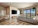 Living room features floor-to-ceiling windows offering city views, sleek furniture, and an open concept layout at 1643 Boulder St # 211, Denver, CO 80211