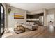 Bright living room with a comfortable sectional sofa, a modern coffee table, and stainless steel kitchen appliances at 1643 Boulder St # 211, Denver, CO 80211