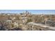 An expansive cityscape view featuring residential rooftops and the Denver skyline, plus mountain views at 1085 N Lafayette St # 804, Denver, CO 80218