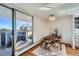 Bright dining area with a modern chandelier, table with seating, and access to the balcony at 1085 N Lafayette St # 804, Denver, CO 80218
