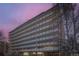 Mid-rise condo building featuring private balconies against a colorful dusk sky, surrounded by mature trees at 1085 N Lafayette St # 804, Denver, CO 80218