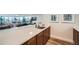 Modern kitchen bar area with stainless steel sink, wooden cabinets, and an open view to the spacious living area at 1085 N Lafayette St # 804, Denver, CO 80218