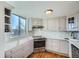 Well-lit kitchen with white cabinets, stainless steel appliances, stone countertops, and a window with a view at 1085 N Lafayette St # 804, Denver, CO 80218
