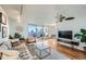 Bright living room featuring hardwood floors, modern furnishings, and a sliding glass door leading to a balcony at 1085 N Lafayette St # 804, Denver, CO 80218