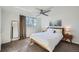 Sunlit bedroom with a ceiling fan, large window, hardwood floors, and modern decor at 1085 N Lafayette St # 804, Denver, CO 80218