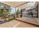 An outdoor kitchen elevates this deck, which features an outdoor lounge area and sunshade at 2452 S Norfolk St, Aurora, CO 80013