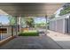 This concrete patio features a sunshade, a lounge area, and a spacious, well-kept yard at 2452 S Norfolk St, Aurora, CO 80013