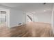 Spacious finished basement features wood-look flooring, stairs, and an open doorway to another room at 2452 S Norfolk St, Aurora, CO 80013