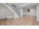 Finished basement with staircase, shelves, wood-look flooring, and a window for natural light at 2452 S Norfolk St, Aurora, CO 80013