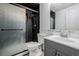 Modern bathroom with a glass door shower and black tiling at 2452 S Norfolk St, Aurora, CO 80013