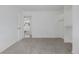 Bright bedroom featuring neutral carpet, walk-in closet, and an open doorway to another room at 2452 S Norfolk St, Aurora, CO 80013