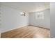Unfinished basement space with laminate floors and two windows at 2452 S Norfolk St, Aurora, CO 80013