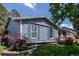 Inviting single-story home featuring blue shutters, complemented by a well-maintained lawn and landscaping at 2452 S Norfolk St, Aurora, CO 80013