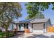 Charming single Gathering home with attached garage, landscaped yard, and solar panels on the roof at 2452 S Norfolk St, Aurora, CO 80013