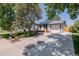 Charming home exterior with a well-maintained lawn, a large driveway and welcoming front porch at 2452 S Norfolk St, Aurora, CO 80013