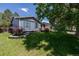 View of a house with a manicured front lawn and landscaping. The exterior features blue siding at 2452 S Norfolk St, Aurora, CO 80013