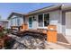 Charming front porch with blue door and wood accents, perfect for relaxing outdoors at 2452 S Norfolk St, Aurora, CO 80013