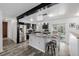 Modern kitchen boasts a large island with seating, stainless steel appliances, and stylish black and white cabinetry at 2452 S Norfolk St, Aurora, CO 80013
