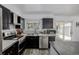 Lovely kitchen with stainless steel appliances, light countertops and backsplash, and dark cabinets at 2452 S Norfolk St, Aurora, CO 80013