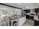 Well-appointed kitchen with island featuring barstool seating, stainless steel appliances, and easy access to living room at 2452 S Norfolk St, Aurora, CO 80013