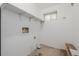 This laundry room features ample storage with built-in shelving and natural light at 2452 S Norfolk St, Aurora, CO 80013