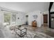Bright and open living area featuring hardwood floors, modern decor, and a built-in entryway bench at 2452 S Norfolk St, Aurora, CO 80013