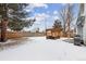 Snowy backyard featuring a pergola with seating, a fenced perimeter, and a barbecue grill at 17794 E Bellewood Dr, Aurora, CO 80015