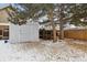 View of a spacious backyard featuring a storage shed and a chicken coop, offering functionality and outdoor living at 17794 E Bellewood Dr, Aurora, CO 80015