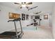 A spacious basement with a ceiling fan, carpeted floor, a work-out area with treadmill and weight bench at 17794 E Bellewood Dr, Aurora, CO 80015